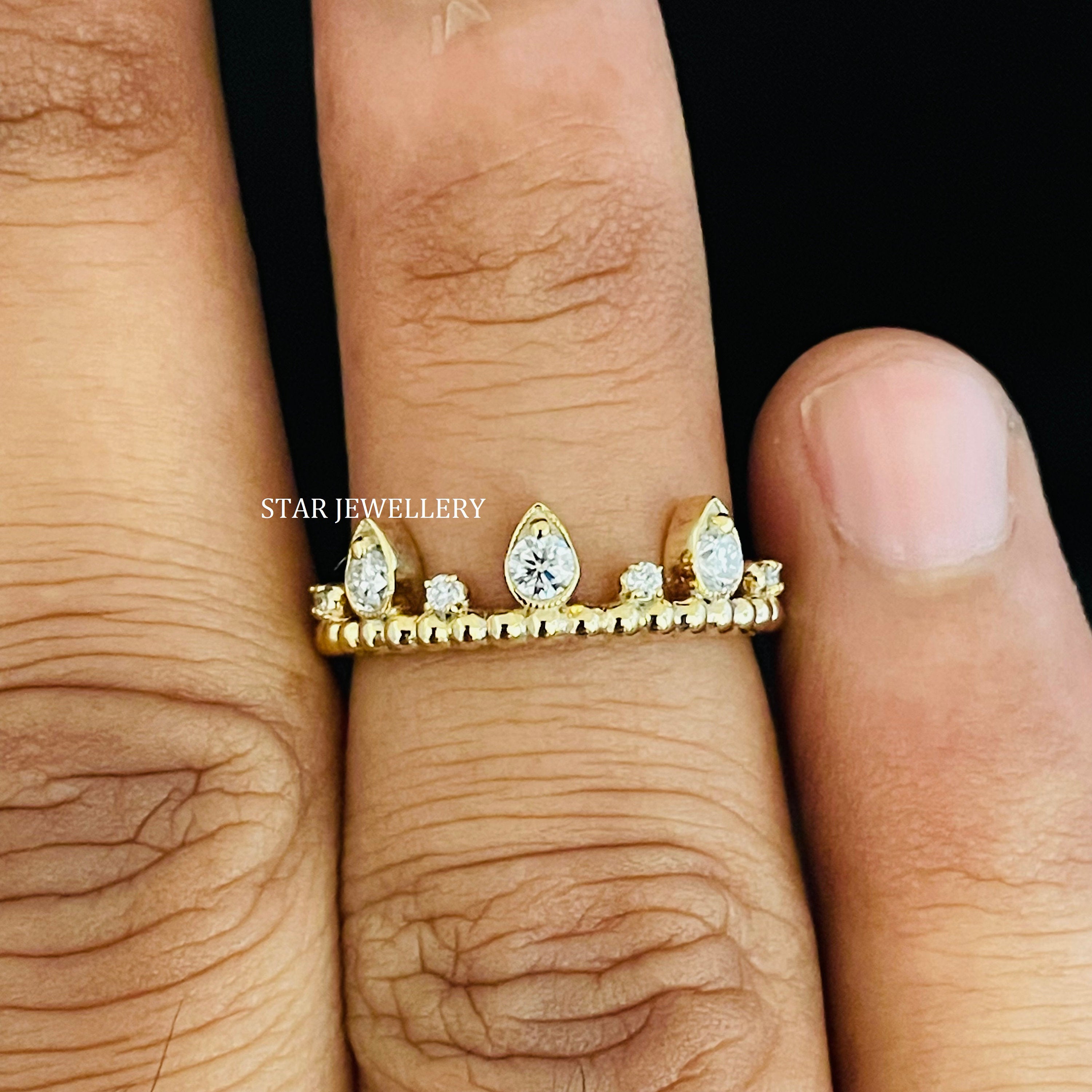 14K solid gold stackable natural diamond wedding band worn alongside an engagement ring