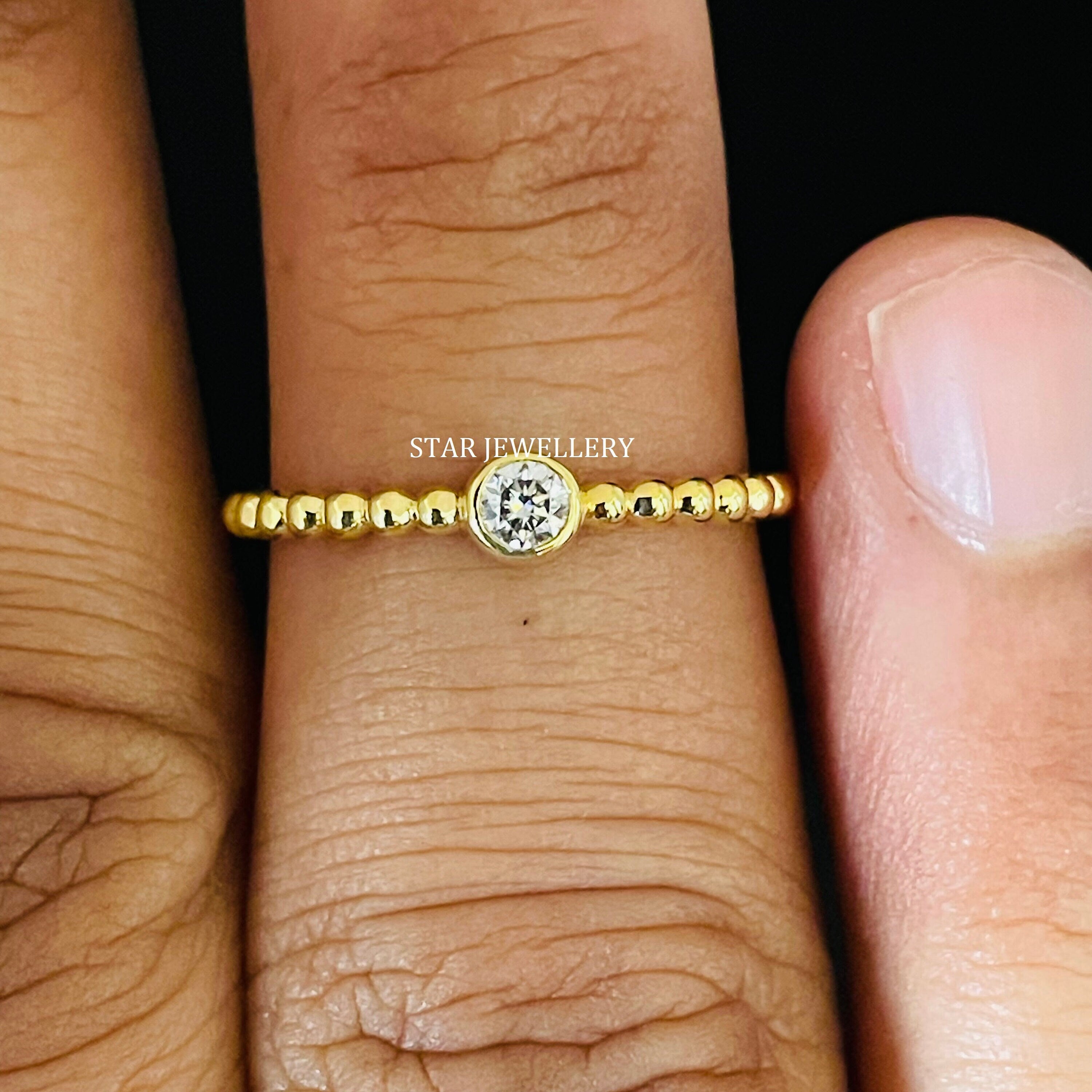 Bezel set natural diamond ring with a beaded shank, styled for minimalist ring stacking